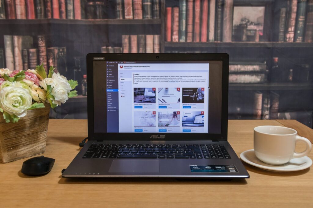 black laptop computer on brown wooden table